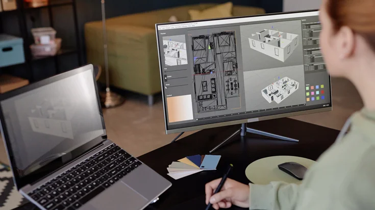 Person designing a floor plan on a large screen