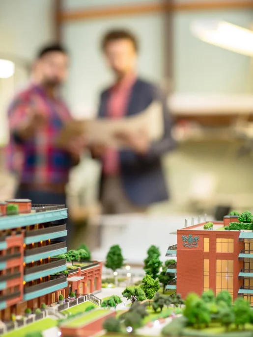 City planning model with blurred people in background
