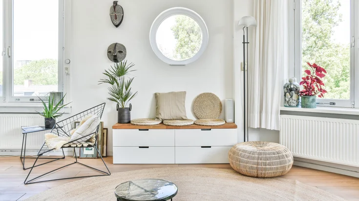 Cozy corner with a round window and wire chair