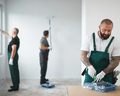 A team of painters preparing their tools and supplies