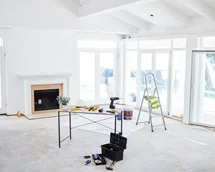 Empty room being renovated with tools and equipment